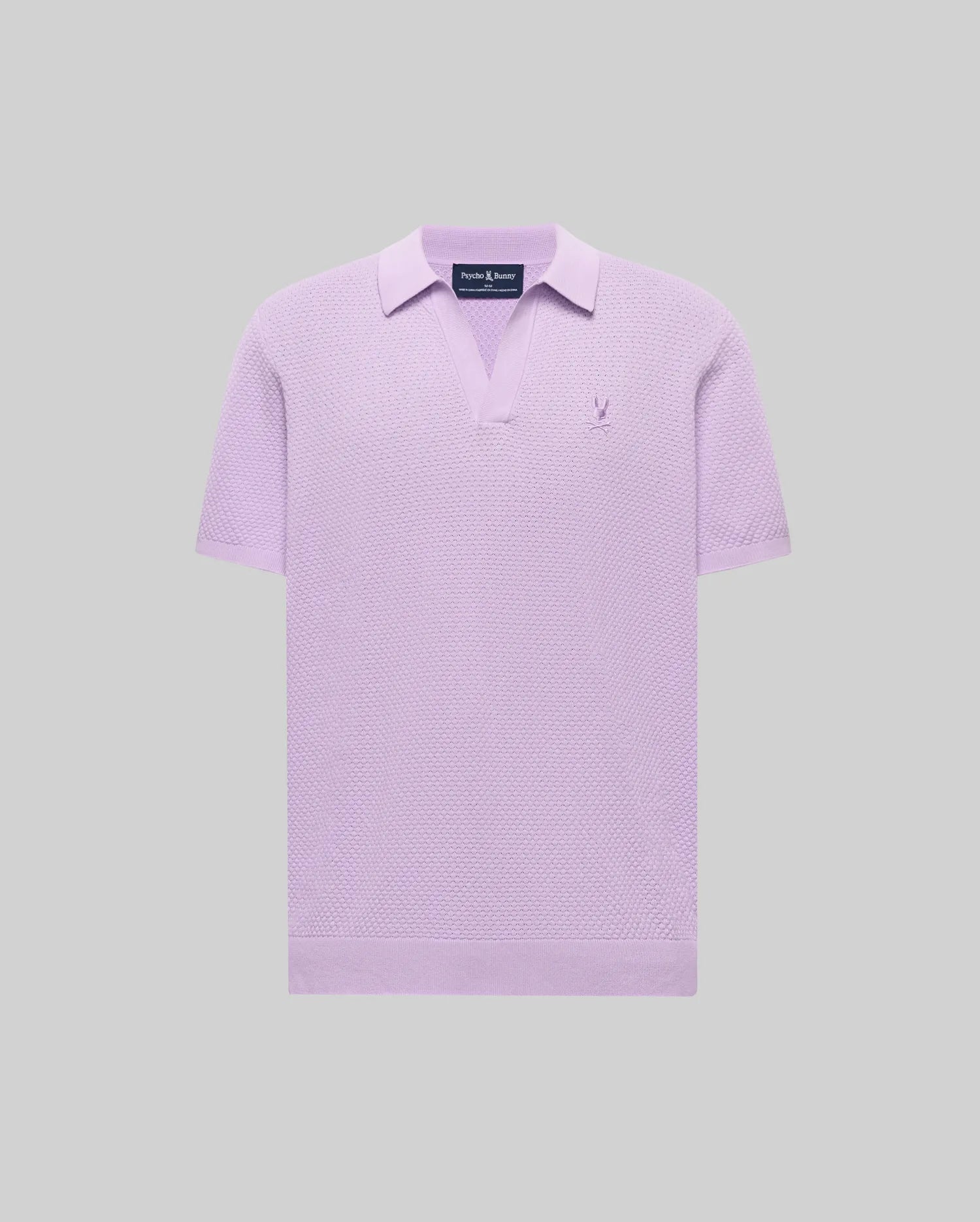 Mens Devon Knit Polo in lavender, featuring a textured knit fabric, open V-neck collar, and a small embroidered Psycho Bunny skull logo on the left chest.