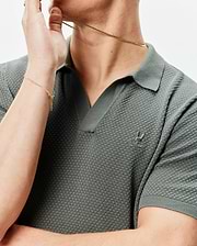 Mens Devon Knit Polo in dark sage green, featuring a textured knit fabric, open V-neck collar, and a small, tonal embroidered Psycho Bunny skull logo on the left chest.