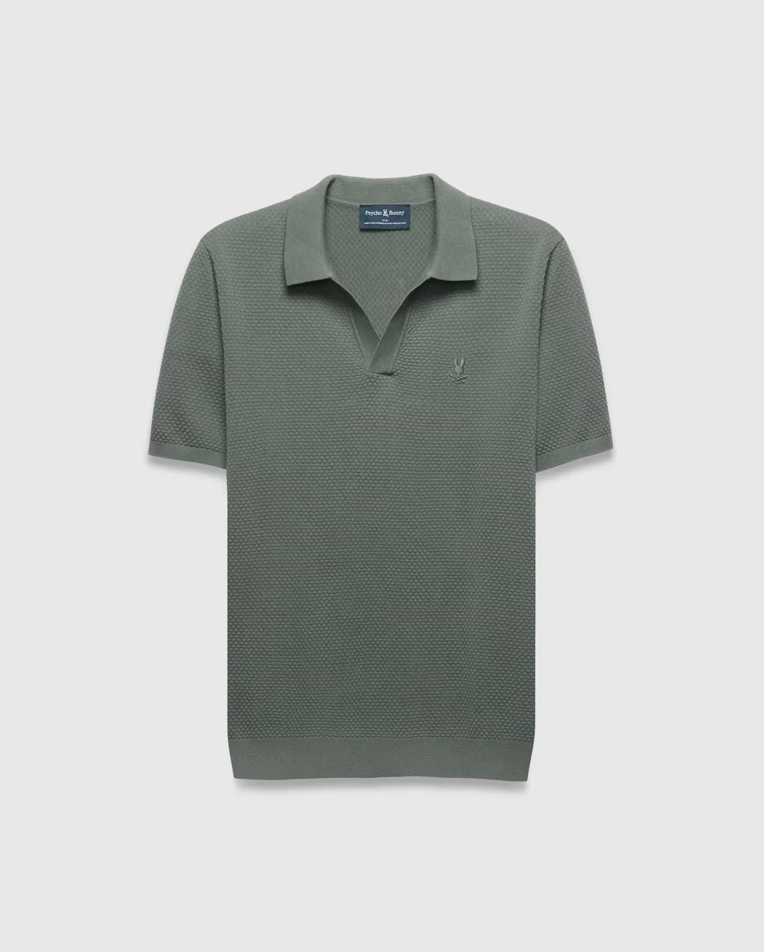 Mens Devon Knit Polo in sage green, a classic fit with textured knit fabric, open collar, and a small tonal embroidered Psycho Bunny skull logo on the left chest.