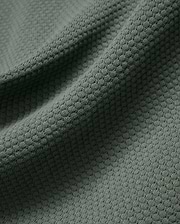 Mens Devon Knit Polo in a rich, muted sage green, featuring a premium, breathable textured knit fabric with a subtle, refined pattern, perfect for elevated streetwear style.