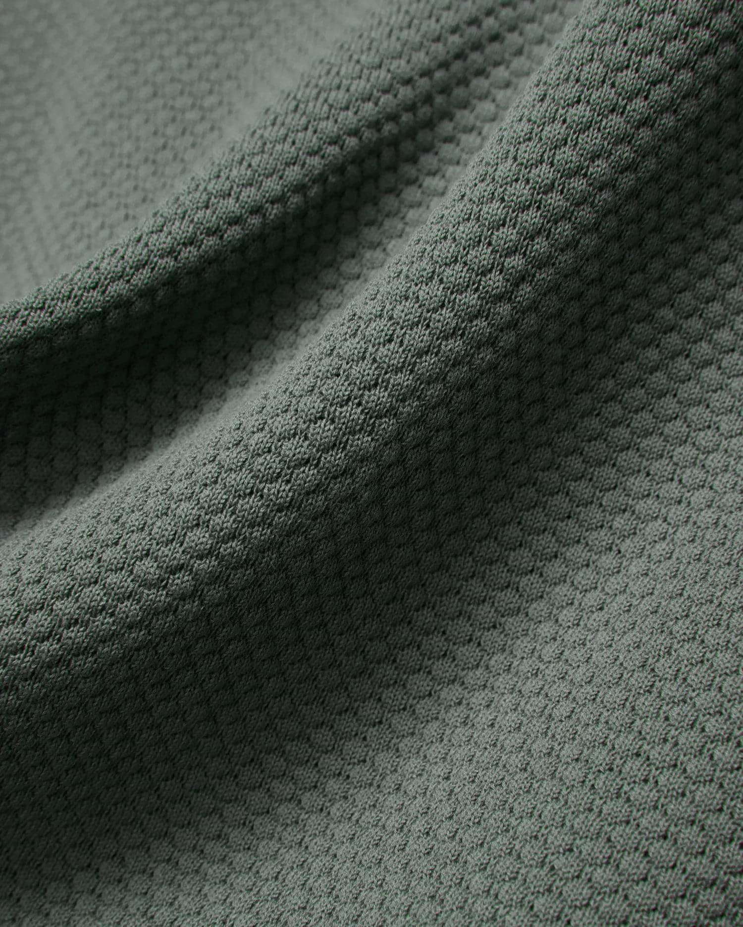 Mens Devon Knit Polo in a rich, muted sage green, featuring a premium, breathable textured knit fabric with a subtle, refined pattern, perfect for elevated streetwear style.
