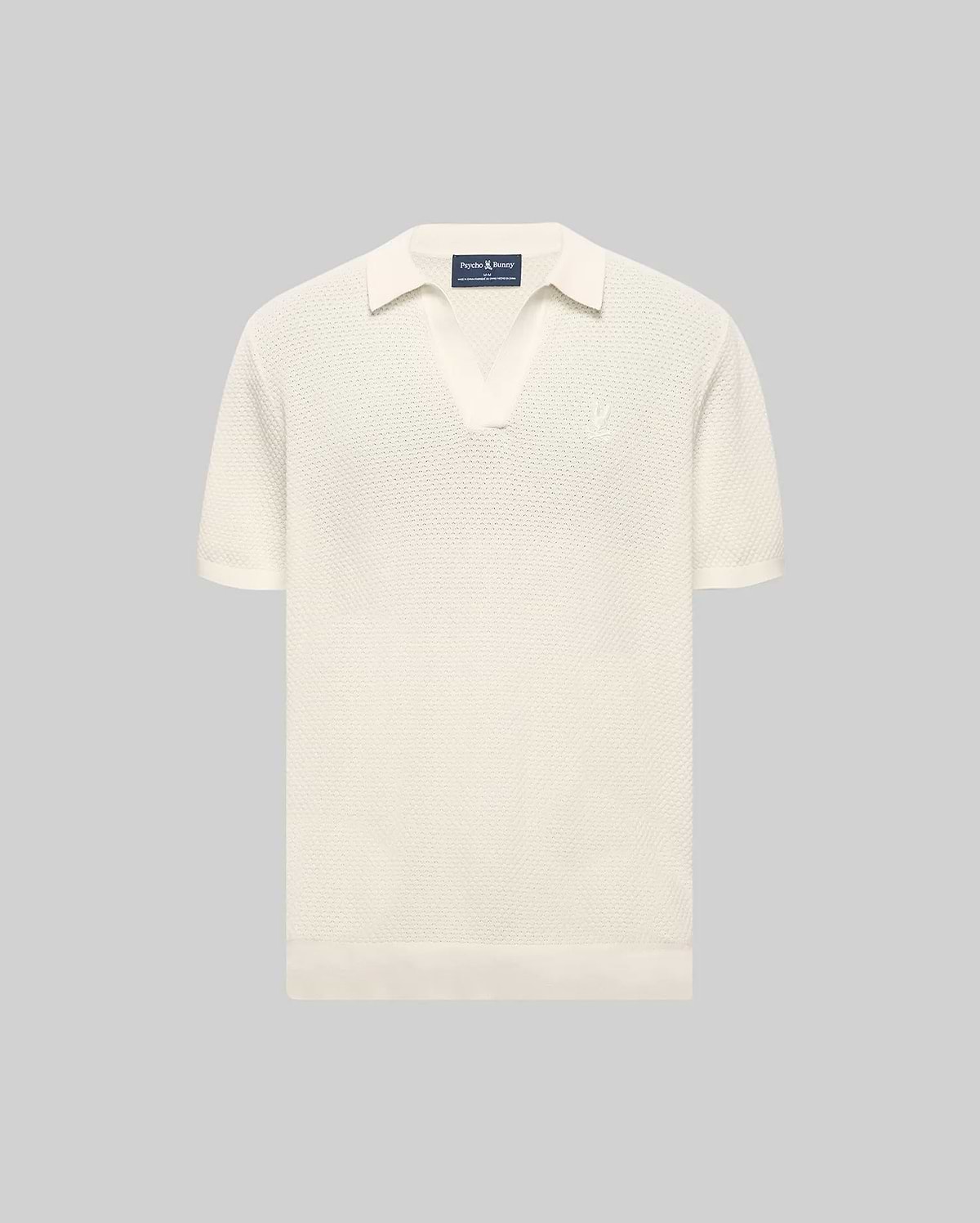 Cream Mens Devon Knit Polo with a textured knit fabric, open collar, short sleeves, ribbed cuffs and hem, featuring a small, tonal embroidered Psycho Bunny skull logo on the left chest.