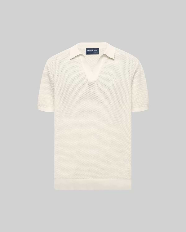 Cream Mens Devon Knit Polo with a textured knit fabric, open collar, short sleeves, ribbed cuffs and hem, featuring a small, tonal embroidered Psycho Bunny skull logo on the left chest.