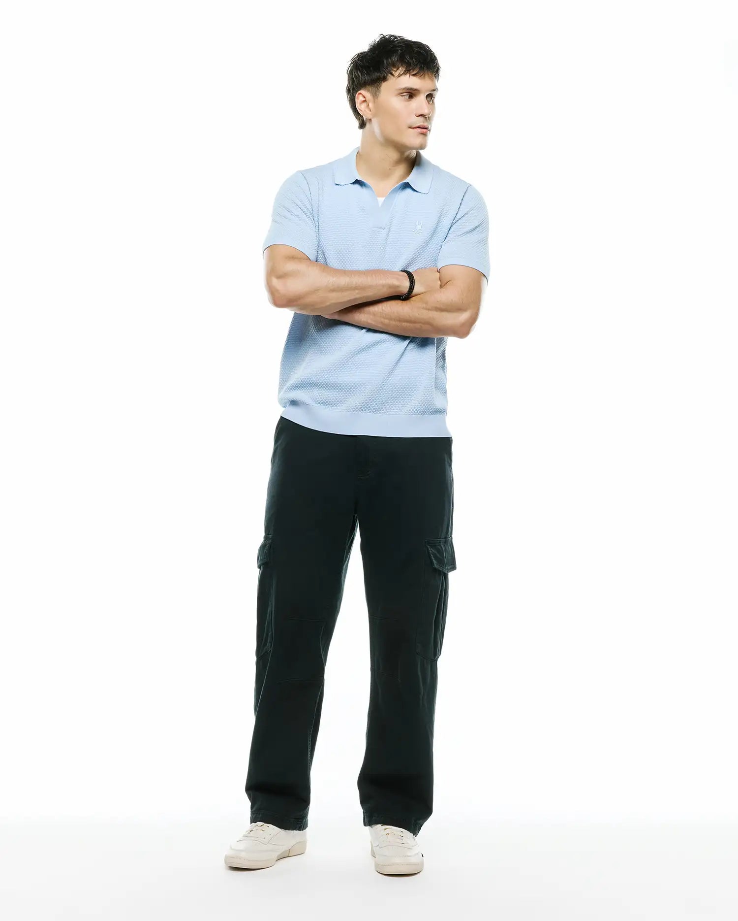 Mens Devon Bubble Stitch Knit Polo, a light blue classic fit polo featuring a textured bubble stitch knit fabric and a small embroidered Psycho Bunny skull logo on the left chest.