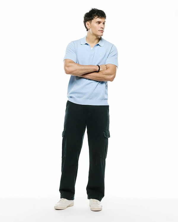 Mens Devon Bubble Stitch Knit Polo, a light blue classic fit polo featuring a textured bubble stitch knit fabric and a small embroidered Psycho Bunny skull logo on the left chest.