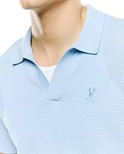 Mens Devon Bubble Stitch Knit Polo in light blue, featuring a unique bubble stitch texture, open placket, and a small, tonal embroidered Psycho Bunny skull logo on the left chest.