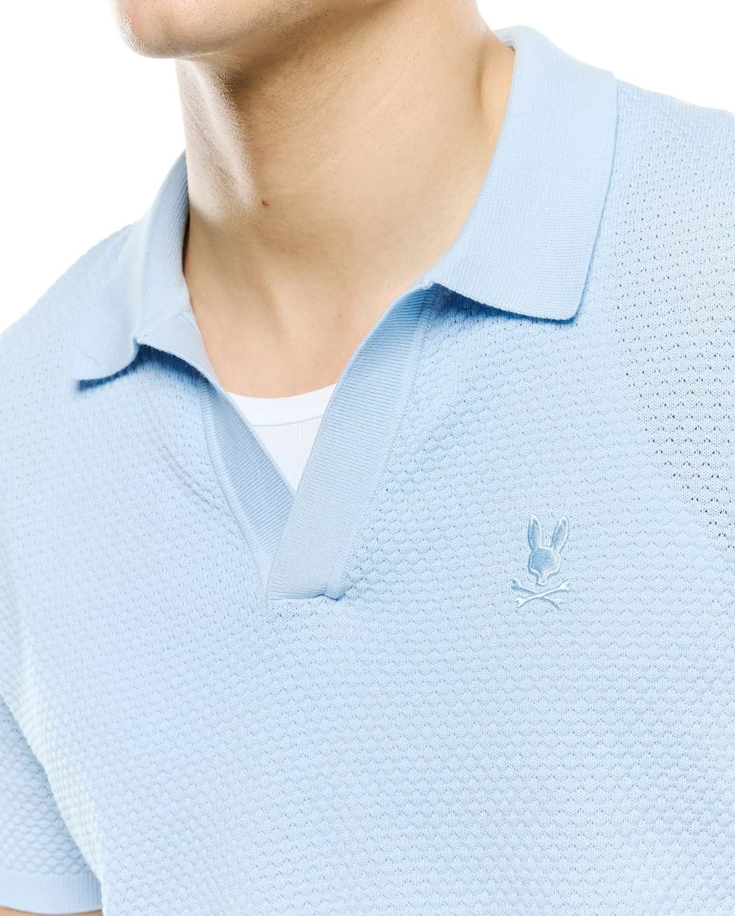 Mens Devon Bubble Stitch Knit Polo in light blue, featuring a unique bubble stitch texture, open placket, and a small, tonal embroidered Psycho Bunny skull logo on the left chest.
