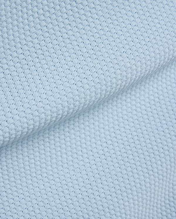 Light blue Mens Devon Bubble Stitch Knit Polo fabric, a premium menswear piece showcasing its unique, refined bubble stitch knit texture, perfect for sophisticated streetwear.