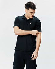 Mens Edwin Sport Polo, a classic fit black pique knit polo shirt with white tipping on the collar and cuffs, featuring a small embroidered pink, white, and light blue Psycho Bunny skull logo on the left chest.
