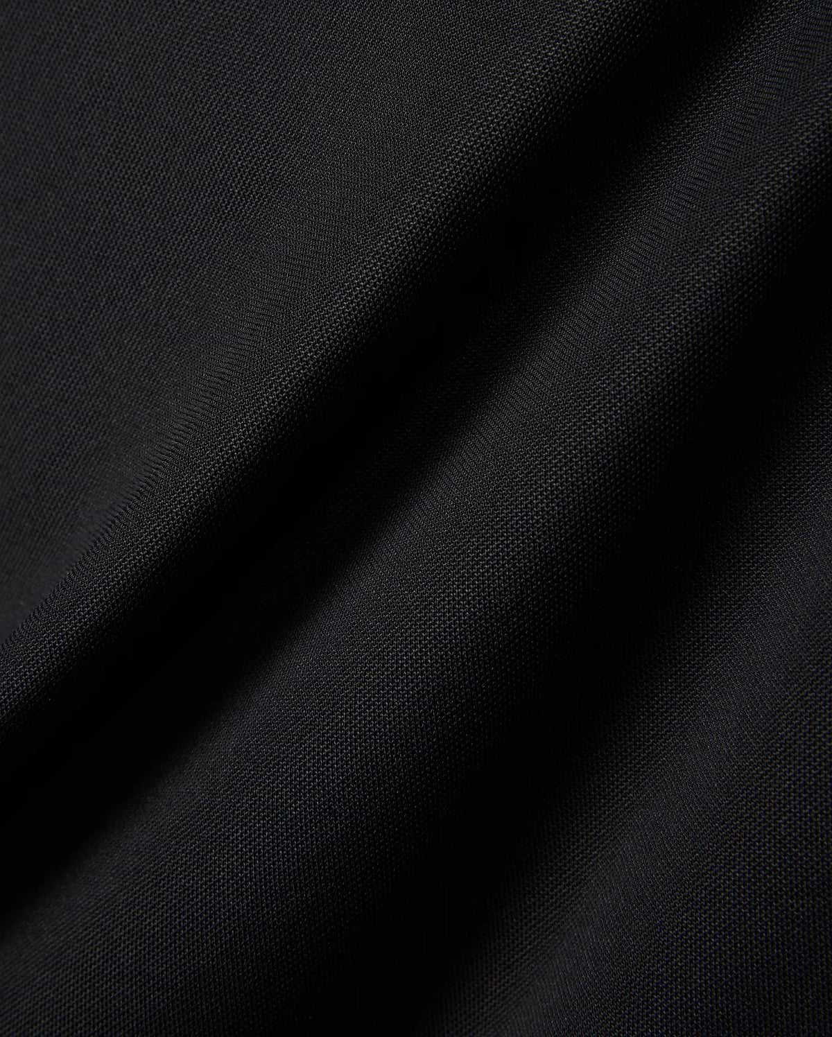 MENS EDWIN SPORT POLO in premium black pique fabric, featuring a classic fit and the signature embroidered Psycho Bunny skull logo on the chest, embodying refined streetwear style.