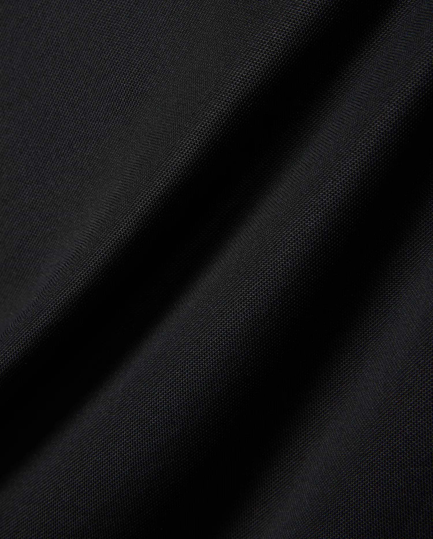 MENS EDWIN SPORT POLO in premium black pique fabric, featuring a classic fit and the signature embroidered Psycho Bunny skull logo on the chest, embodying refined streetwear style.