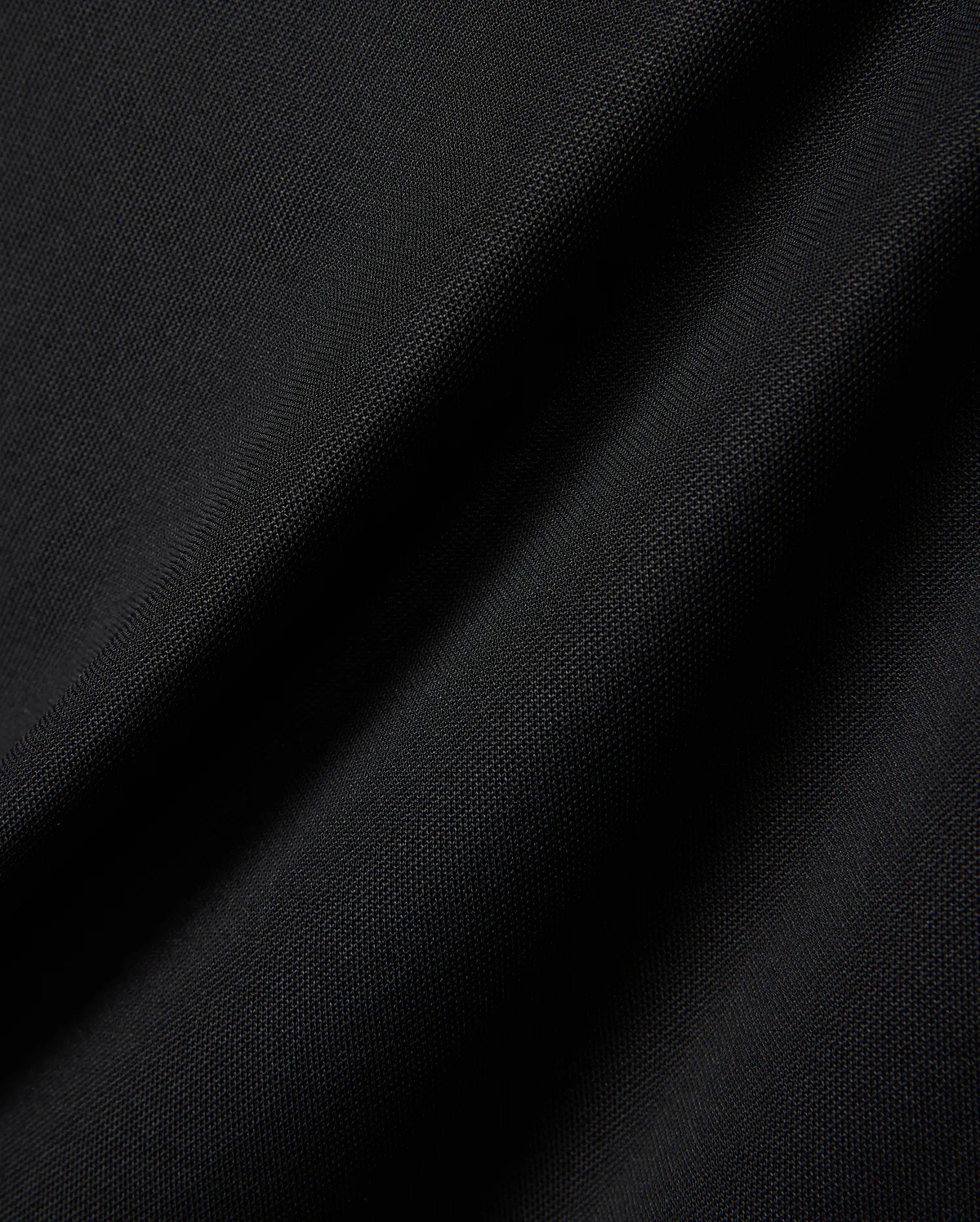 MENS EDWIN SPORT POLO in premium black pique fabric, featuring a classic fit and the signature embroidered Psycho Bunny skull logo on the chest, embodying refined streetwear style.