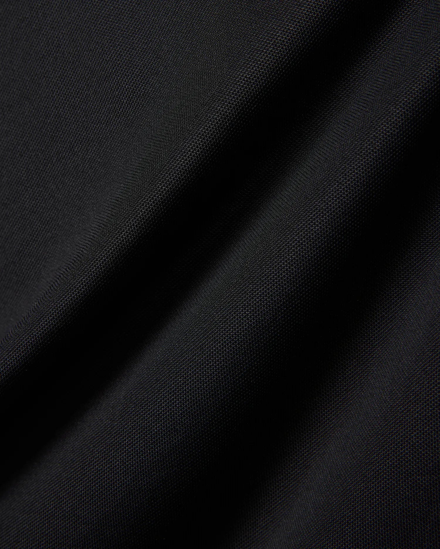 MENS EDWIN SPORT POLO in premium black pique fabric, featuring a classic fit and the signature embroidered Psycho Bunny skull logo on the chest, embodying refined streetwear style.