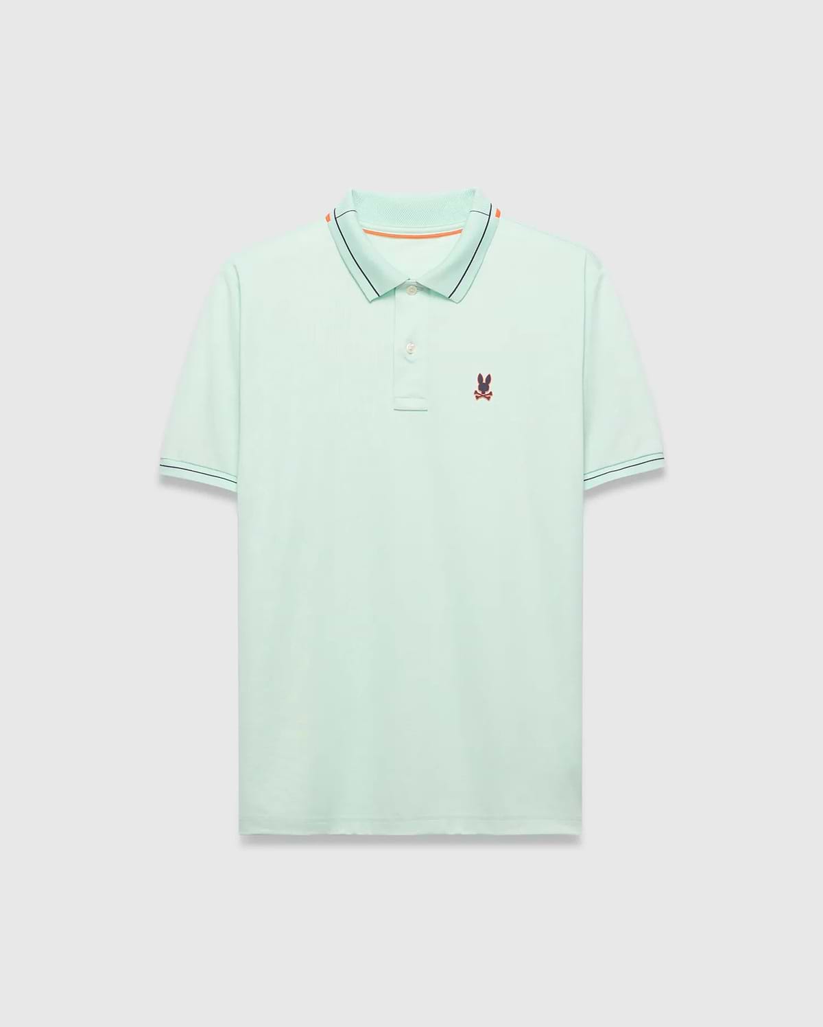Mens Edwin Sport Polo, a classic fit light green pique polo with a black and orange striped collar, matching black striped cuffs, and a small embroidered Psycho Bunny skull logo on the left chest.
