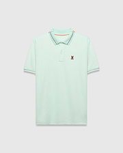 Mens Edwin Sport Polo, a classic fit light green pique polo with a black and orange striped collar, matching black striped cuffs, and a small embroidered Psycho Bunny skull logo on the left chest.
