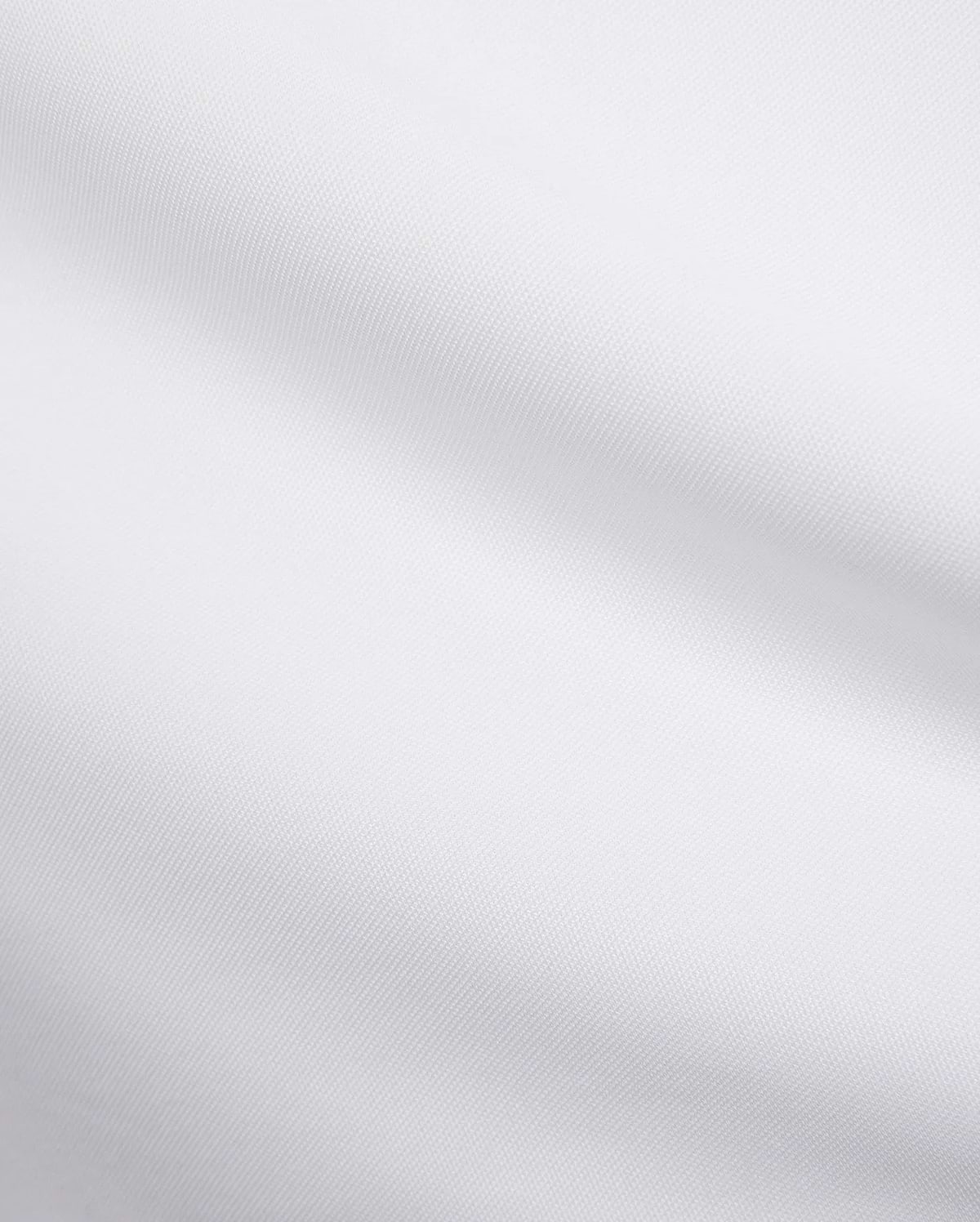Mens Edwin Sport Polo, a premium white pique fabric, showcasing its refined textured weave. This high-quality material is characteristic of Psycho Bunny's sophisticated streetwear.