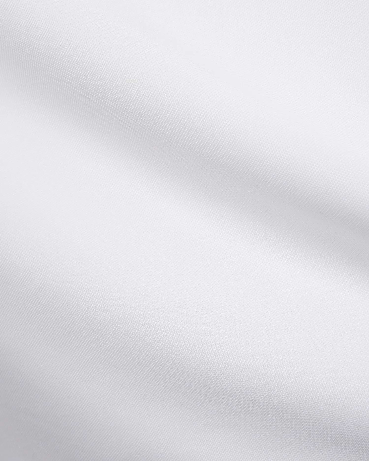 Mens Edwin Sport Polo, a premium white pique fabric, showcasing its refined textured weave. This high-quality material is characteristic of Psycho Bunny's sophisticated streetwear.