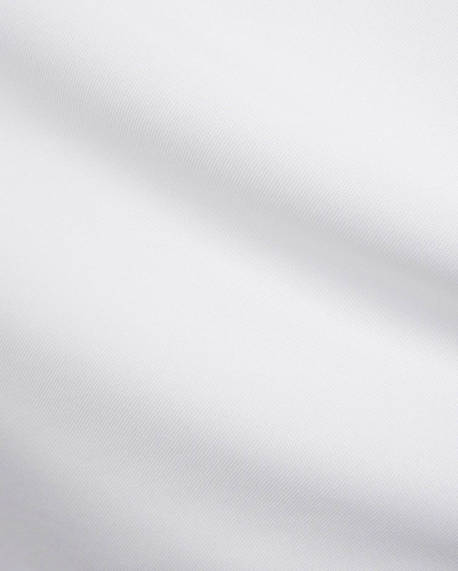 Mens Edwin Sport Polo, a premium white pique fabric, showcasing its refined textured weave. This high-quality material is characteristic of Psycho Bunny's sophisticated streetwear.