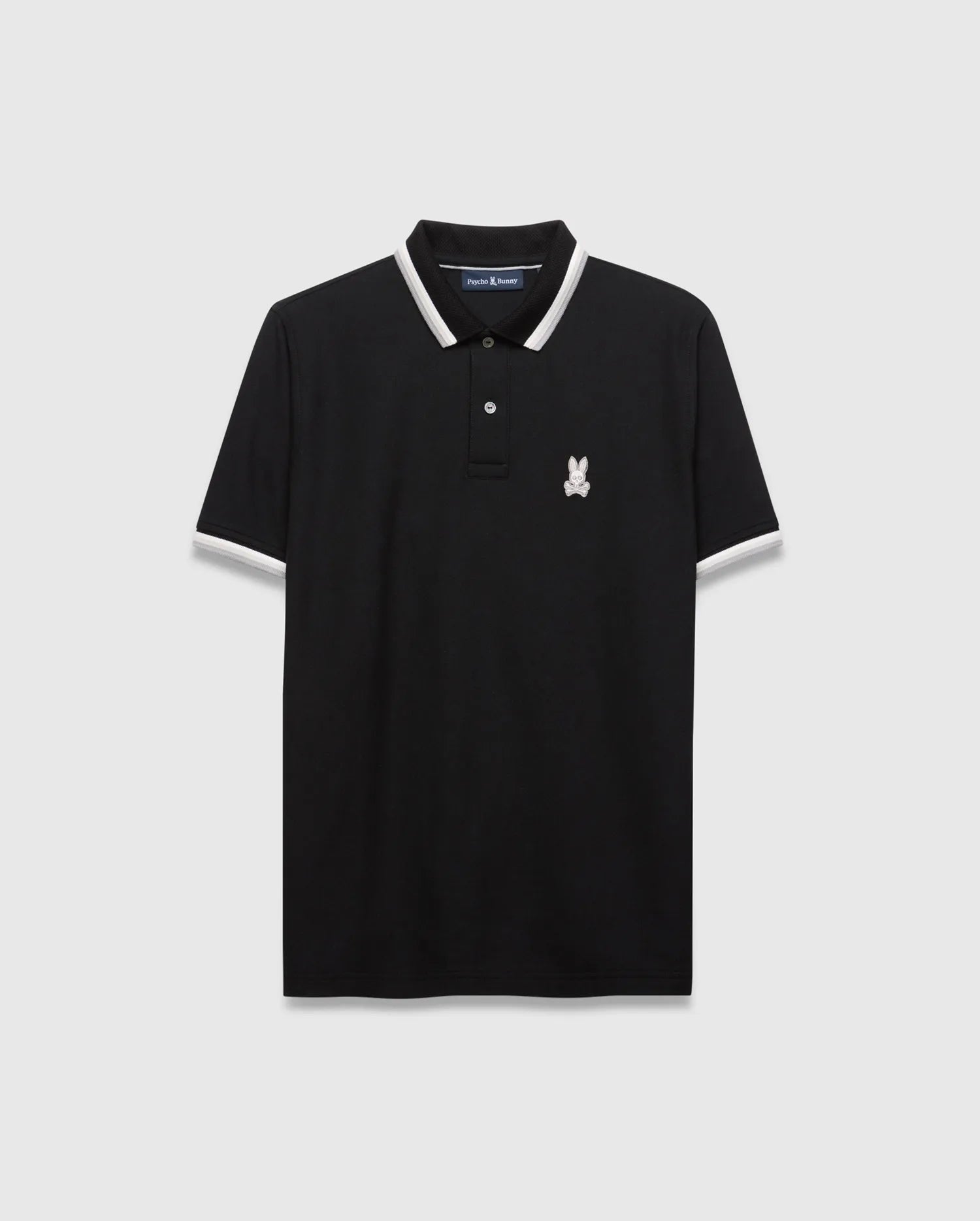 Mens Holden Pique Polo, a classic fit black pique polo shirt with white and grey striped collar and cuffs, featuring a small embroidered white Psycho Bunny skull logo on the left chest.