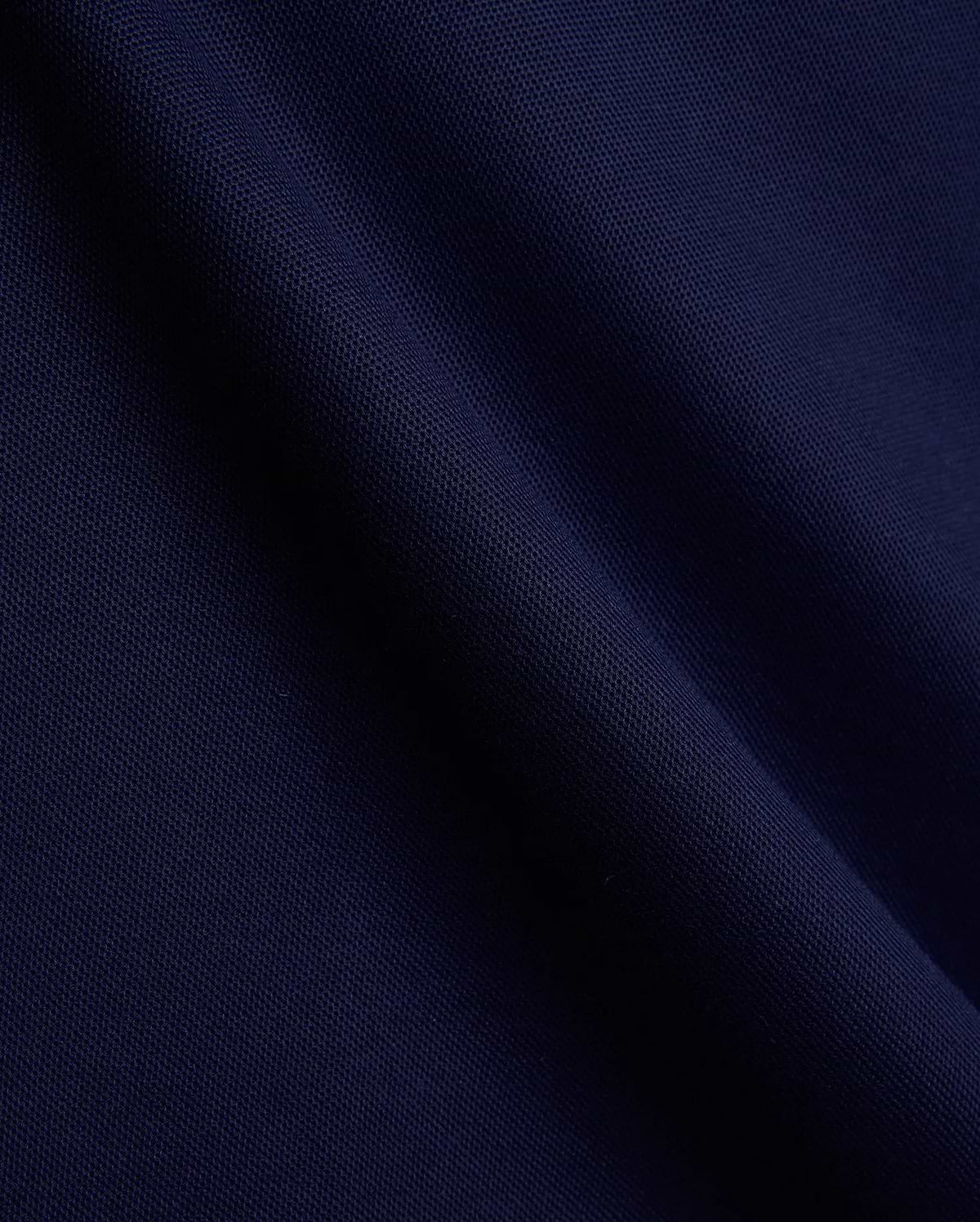 Mens Holden Pique Polo in rich navy blue, crafted from premium textured pique fabric, featuring the iconic embroidered Psycho Bunny skull logo on the chest, a hallmark of refined streetwear.