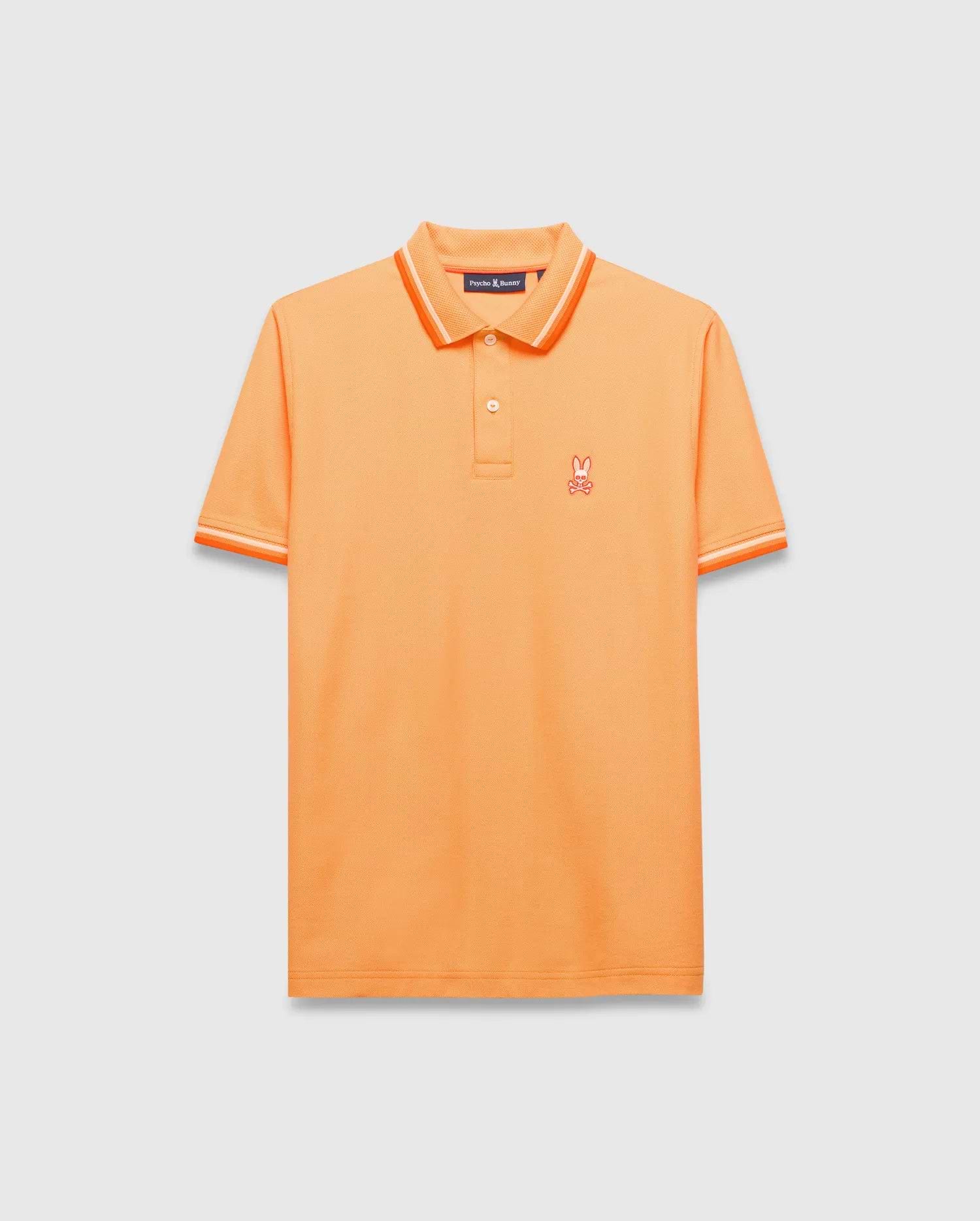 Mens Holden Pique Polo, vibrant orange classic fit pique knit with orange and white tipped collar and cuffs, featuring a small embroidered orange Psycho Bunny skull logo on the left chest.