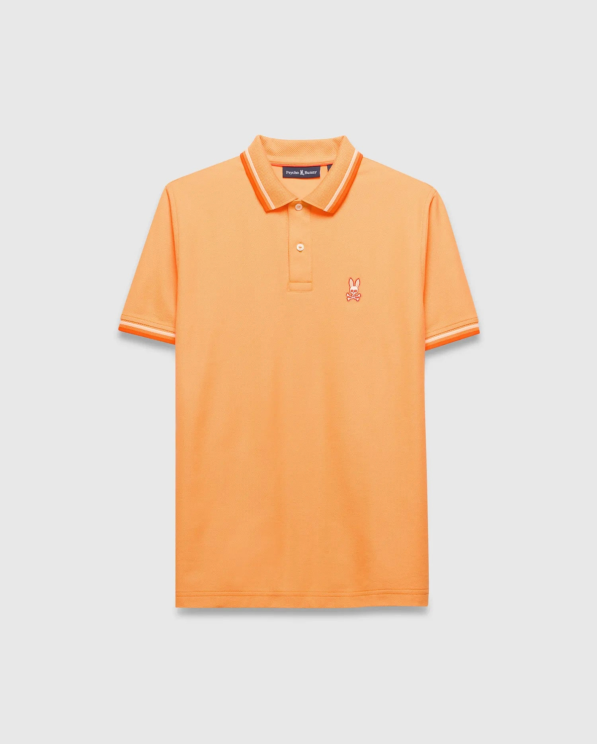 Mens Holden Pique Polo, vibrant orange classic fit pique knit with orange and white tipped collar and cuffs, featuring a small embroidered orange Psycho Bunny skull logo on the left chest.