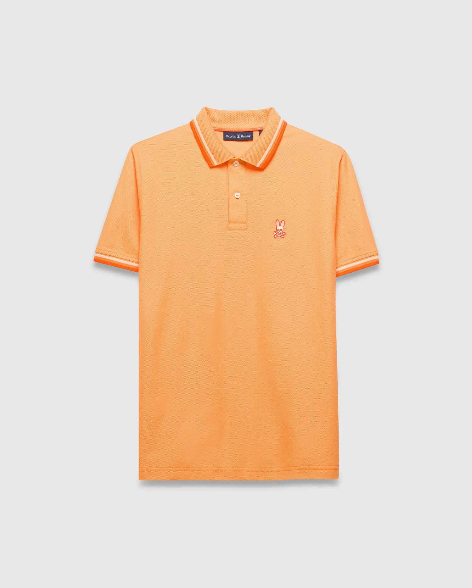 Mens Holden Pique Polo, vibrant orange classic fit pique knit with orange and white tipped collar and cuffs, featuring a small embroidered orange Psycho Bunny skull logo on the left chest.