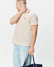Mens Holden Pique Polo, a classic fit khaki pique knit polo with orange striped collar and sleeve cuffs, featuring a small embroidered orange Psycho Bunny skull logo on the left chest.