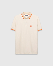 Mens Holden Pique Polo, cream classic fit with textured pique fabric, featuring an orange embroidered Psycho Bunny skull logo on the left chest, and ribbed collar/cuffs with orange and beige stripes.