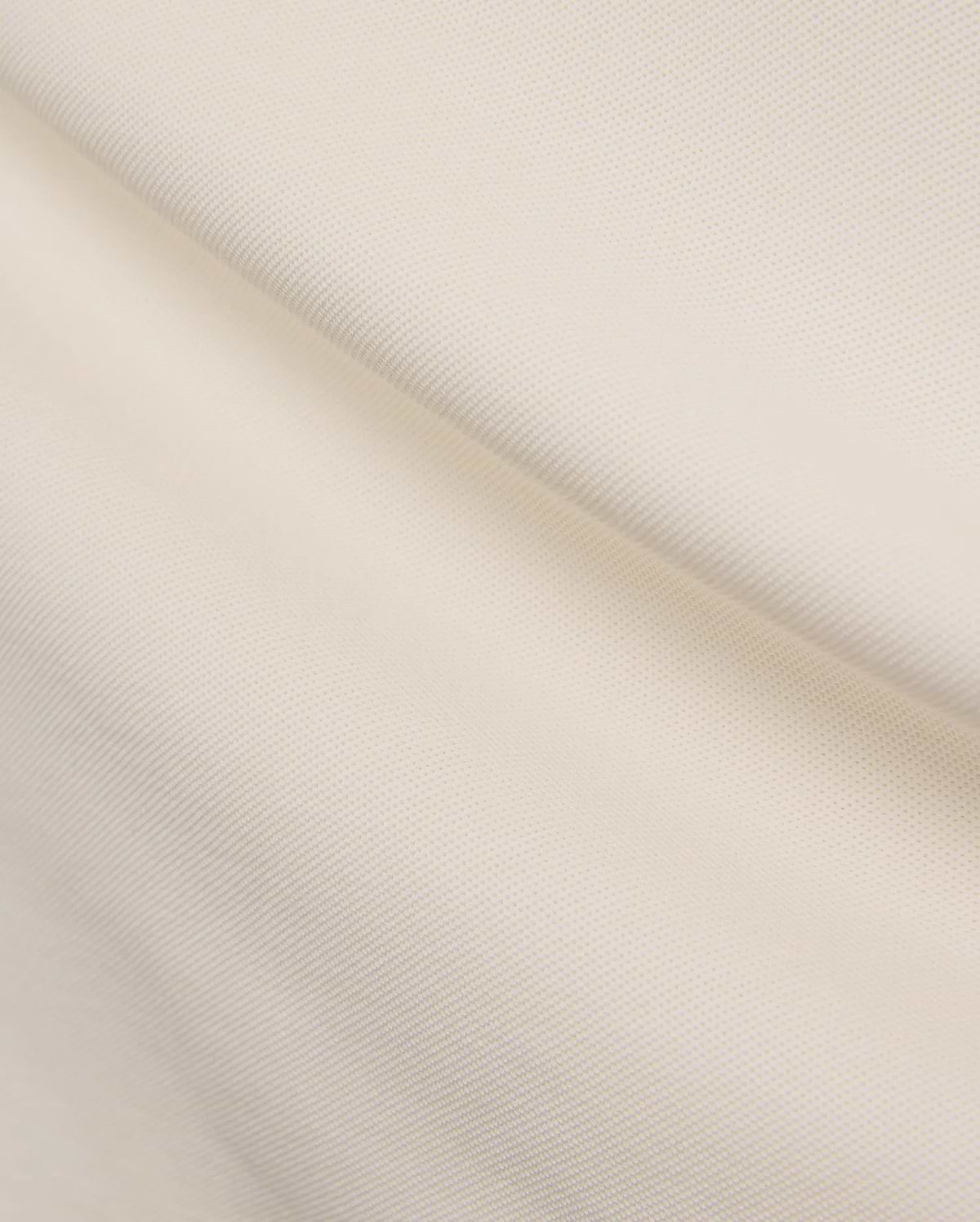 Cream Mens Holden Pique Polo, showcasing its textured pique knit fabric and the iconic small embroidered Psycho Bunny skull logo on the chest.