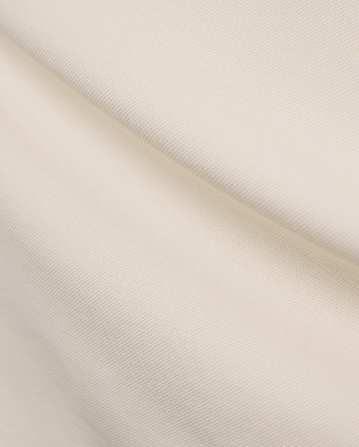 Cream Mens Holden Pique Polo, showcasing its textured pique knit fabric and the iconic small embroidered Psycho Bunny skull logo on the chest.