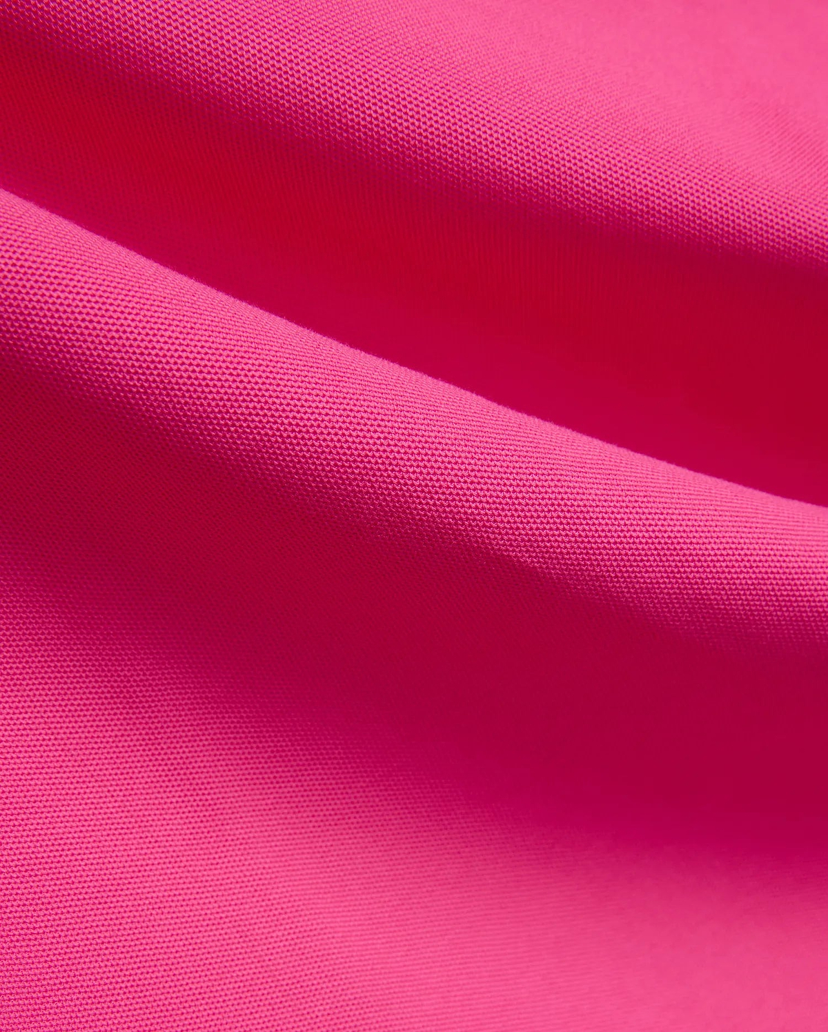 Vibrant fuchsia MENS NATE PIQUE POLO fabric, showcasing its classic textured pique knit weave, embodying Psycho Bunny's bold and refined streetwear style.