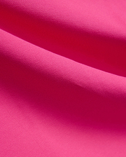 Vibrant fuchsia MENS NATE PIQUE POLO fabric, showcasing its classic textured pique knit weave, embodying Psycho Bunny's bold and refined streetwear style.