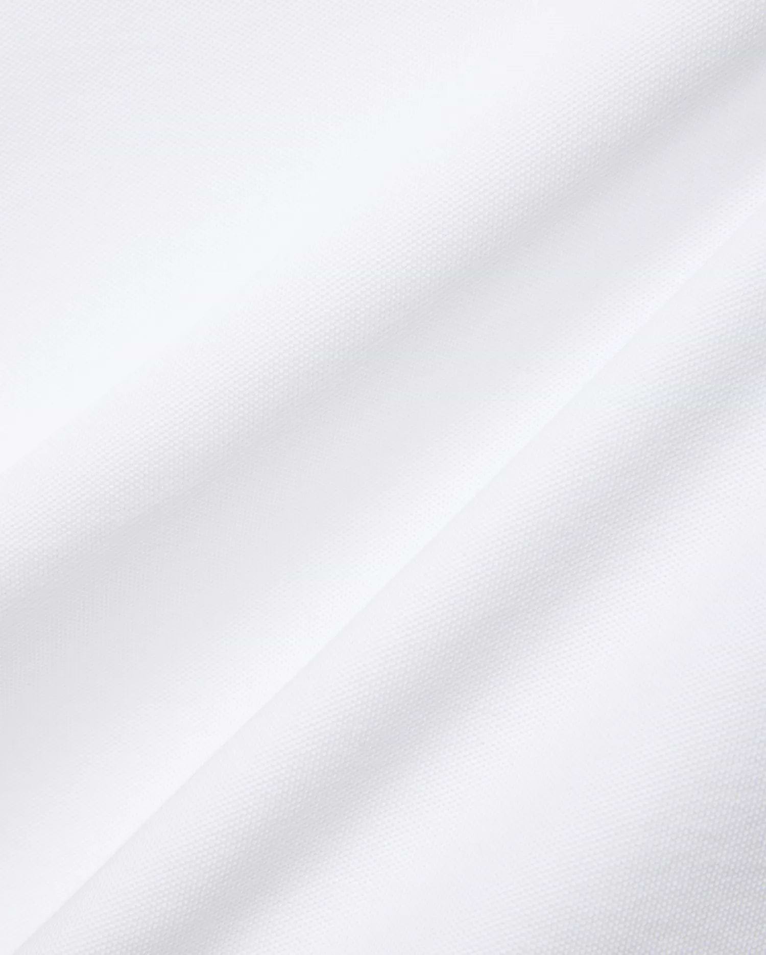 Mens Nate Pique Polo in crisp white, showcasing its premium, breathable, and finely textured pique fabric with subtle diagonal folds, embodying Psycho Bunny's refined streetwear aesthetic.