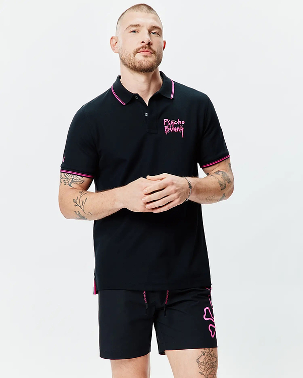 Mens Duncan Pique Polo, black with pink collar and cuff tipping. Features an embroidered pink Psycho Bunny chest logo, small sleeve bunny skull, and pink side vents. Classic fit.