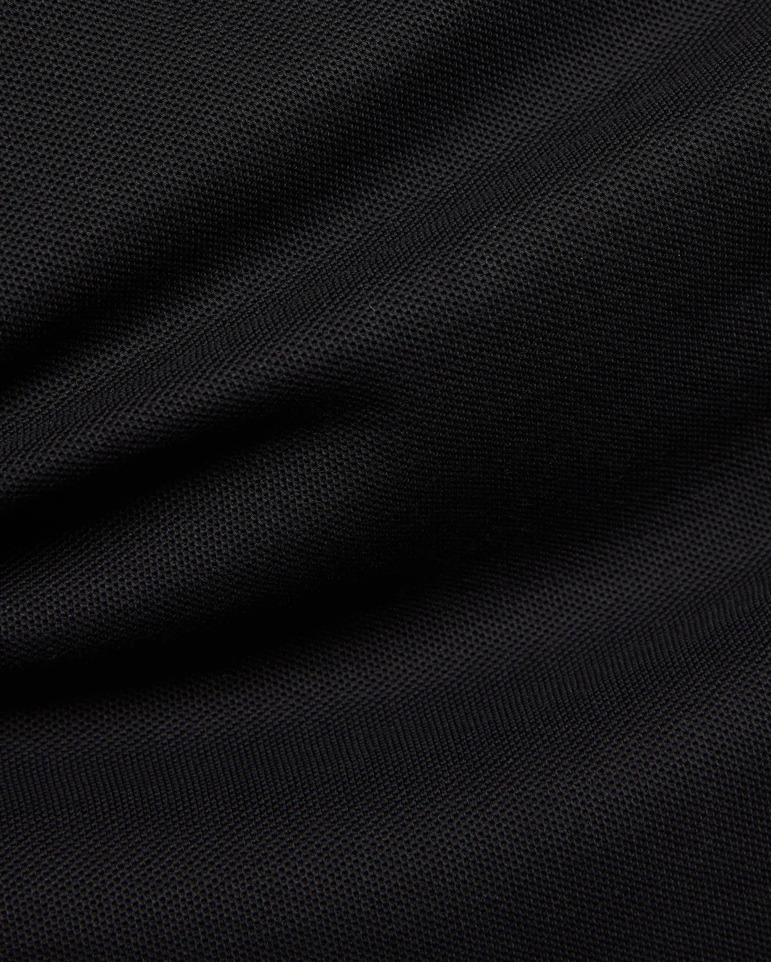 Premium black Mens Duncan Pique Polo, showcasing its breathable, classic pique fabric with a distinct textured weave and subtle folds, perfect for refined streetwear.