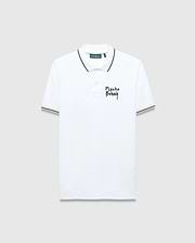 Mens Duncan Pique Polo, white classic fit pique polo with black striped collar and cuffs, featuring a distressed black Psycho Bunny text logo embroidered on the left chest and green neck tape.