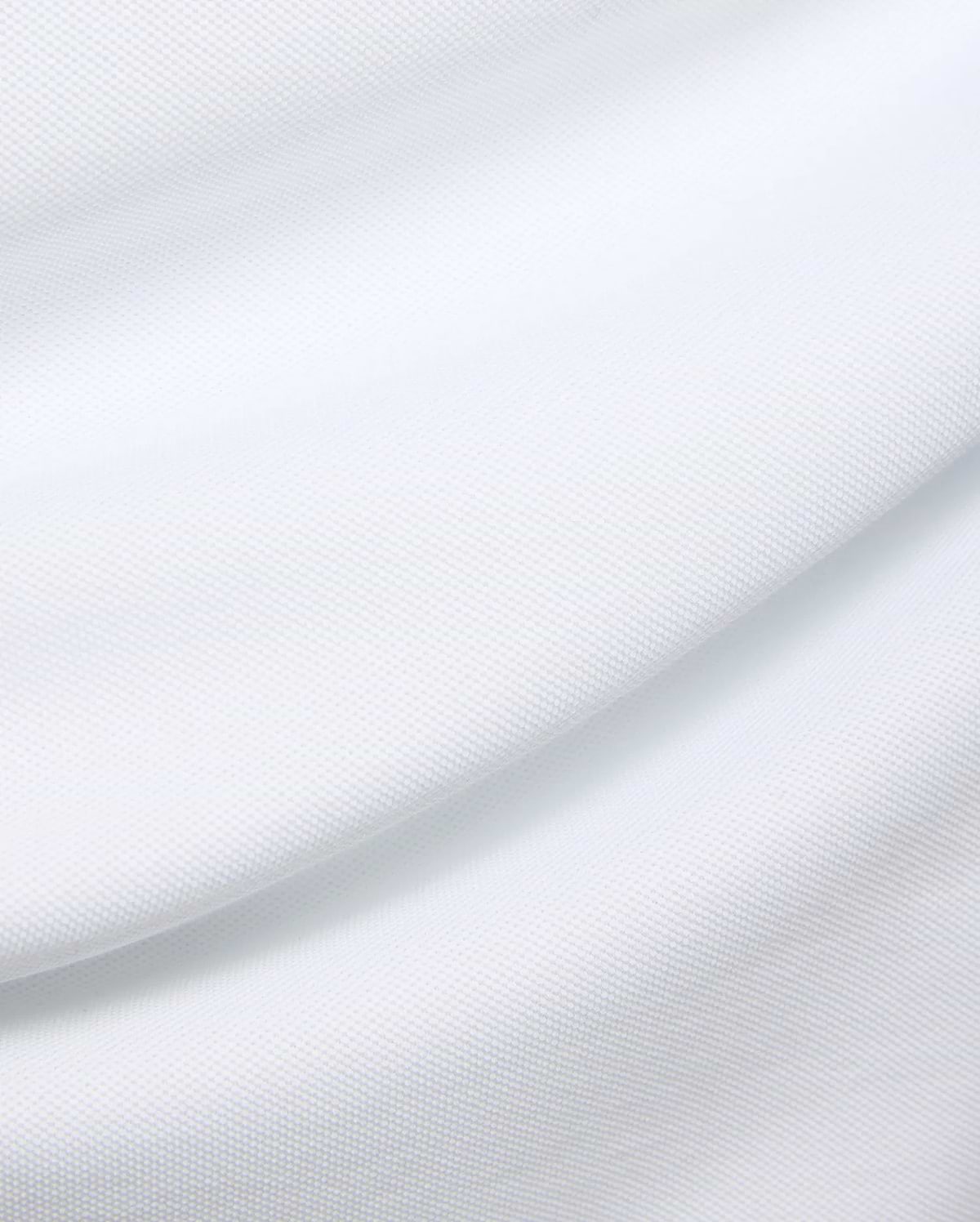 Mens Duncan Pique Polo in crisp white, a premium classic fit polo crafted from finely textured pique knit fabric, embodying Psycho Bunny's refined streetwear aesthetic.
