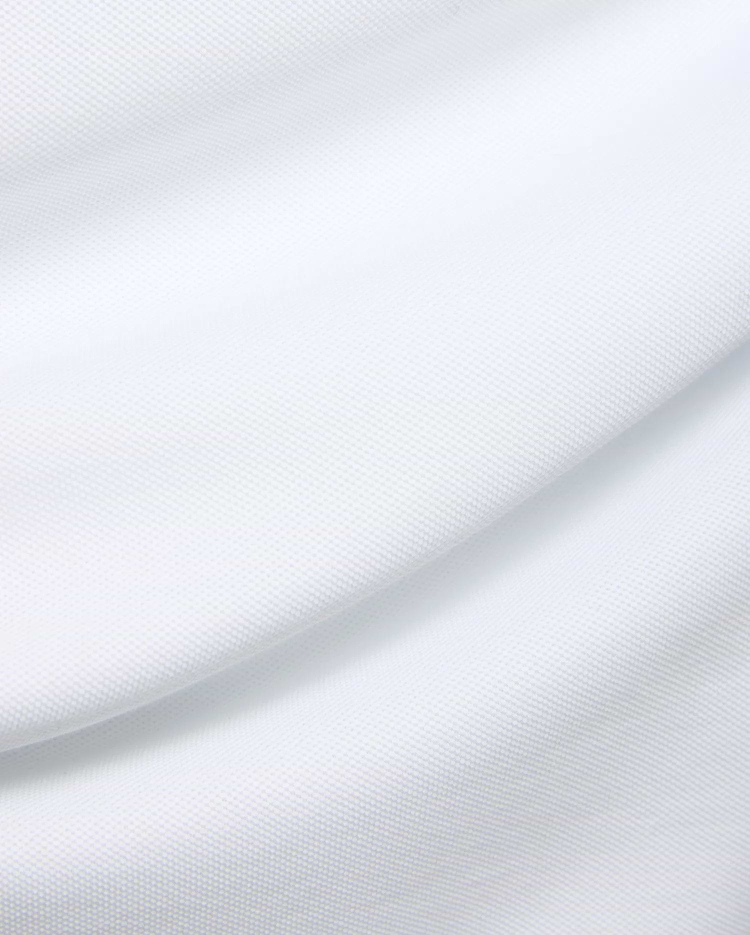 Mens Duncan Pique Polo in crisp white, a premium classic fit polo crafted from finely textured pique knit fabric, embodying Psycho Bunny's refined streetwear aesthetic.