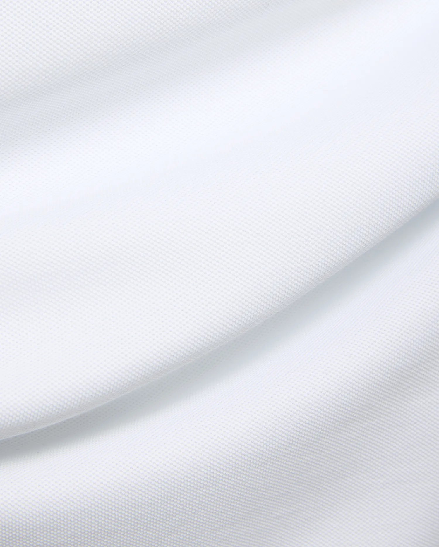 Mens Duncan Pique Polo in crisp white, a premium classic fit polo crafted from finely textured pique knit fabric, embodying Psycho Bunny's refined streetwear aesthetic.