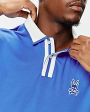 Royal blue Mens Ridley Pique Polo with a classic fit, white ribbed collar, striped placket, and an embroidered white and blue Psycho Bunny skull logo on the left chest.