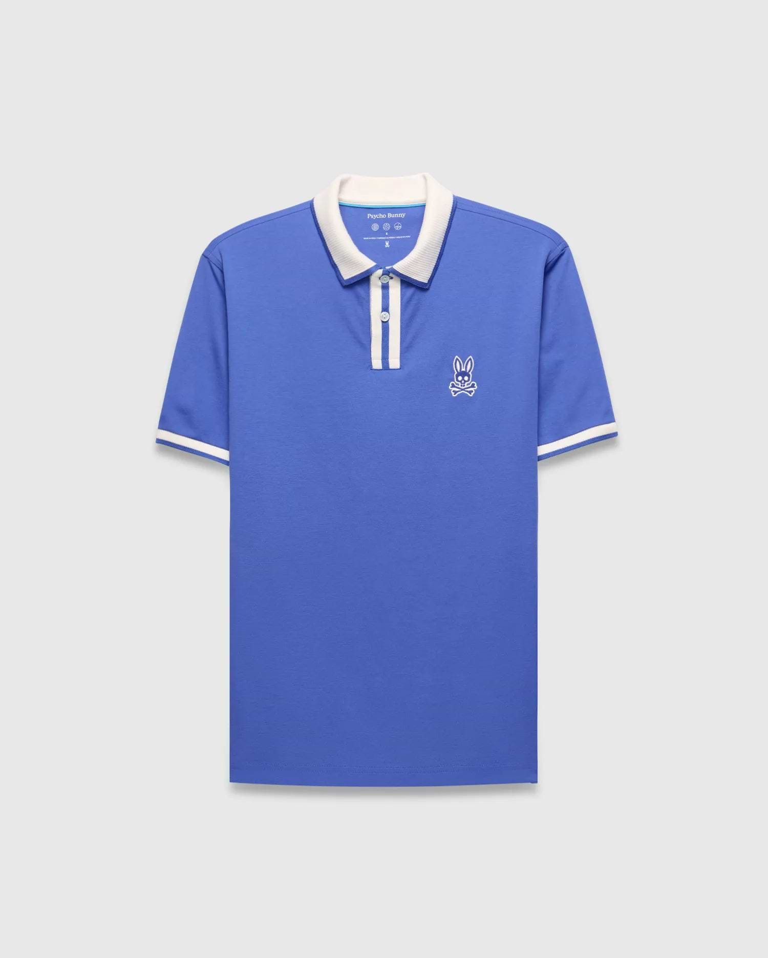 Mens Ridley Pique Polo in blue pique with a white collar, two-button placket, white striped cuffs, and an embroidered white Psycho Bunny skull logo on the left chest.