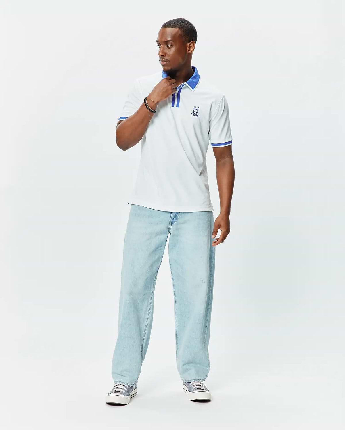 Mens Ridley Pique Polo in white pique, featuring a classic fit, blue striped collar and cuffs, and an embroidered blue Psycho Bunny skull logo on the left chest. (3)