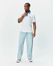 Mens Ridley Pique Polo in white pique, featuring a classic fit, blue striped collar and cuffs, and an embroidered blue Psycho Bunny skull logo on the left chest. (3)