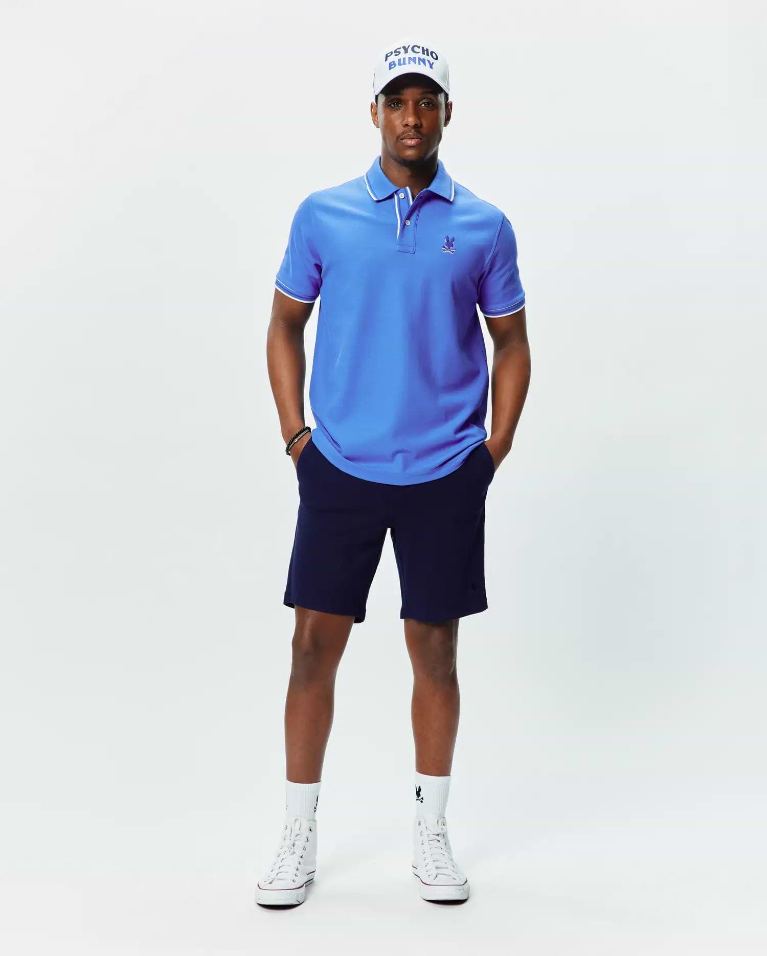 Mens Brad Pique Polo, vibrant blue classic fit pique polo with white tipping on collar and cuffs, featuring a small embroidered blue Psycho Bunny skull logo on the left chest. (3)