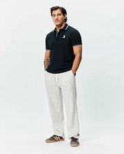 Mens Brad Pique Polo in navy, featuring a classic fit, pique texture, white tipped collar and cuffs, and a small embroidered white Psycho Bunny skull logo on the left chest.