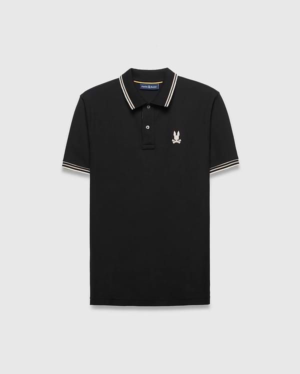 Mens Brad Pique Polo, black classic fit with white and gold striped collar and cuffs, featuring a small embroidered light pink/cream Psycho Bunny skull logo on the left chest.