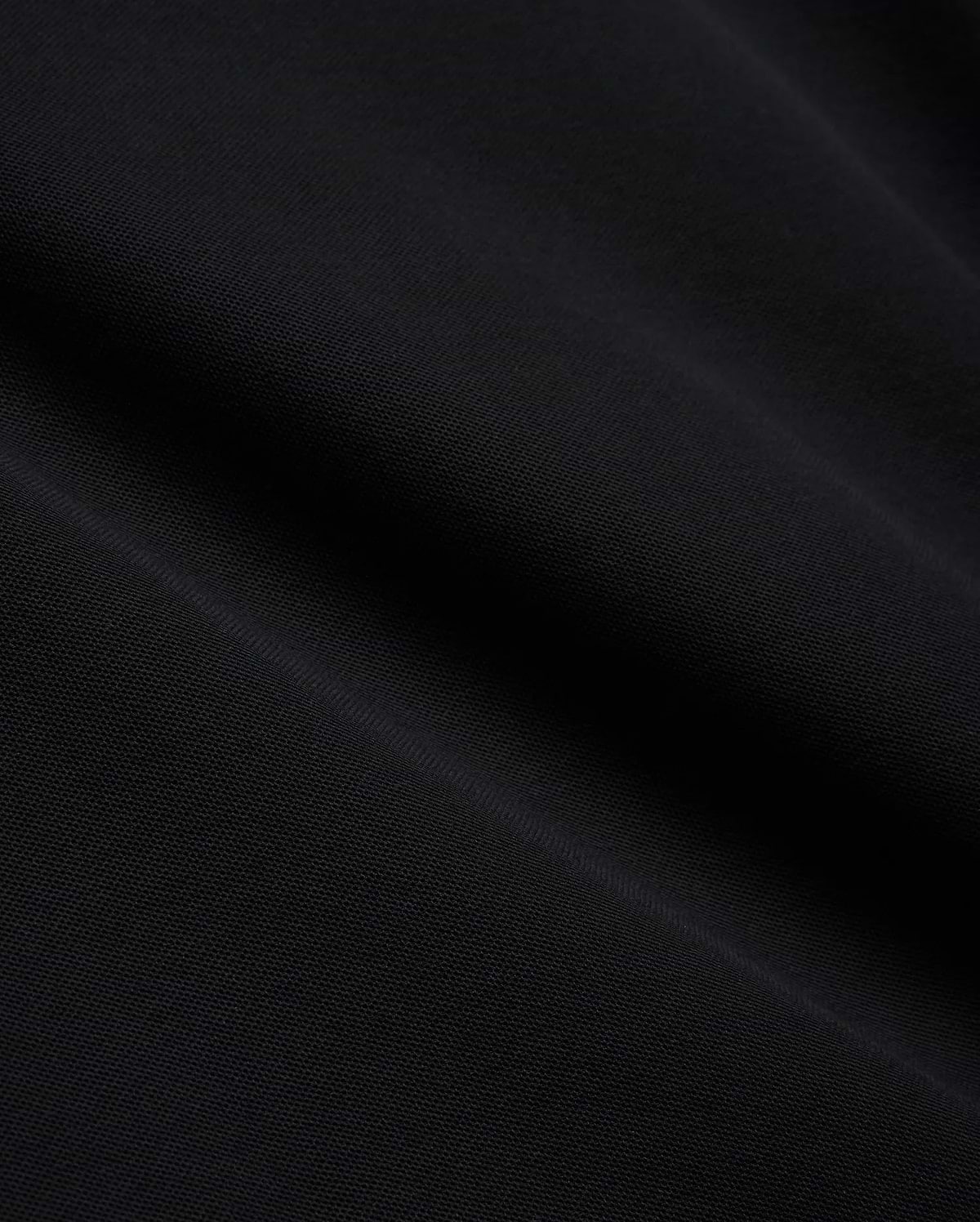 Mens Brad Pique Polo, a premium black pique knit fabric with a subtle, textured weave, showcasing the refined quality and classic style of Psycho Bunny menswear.