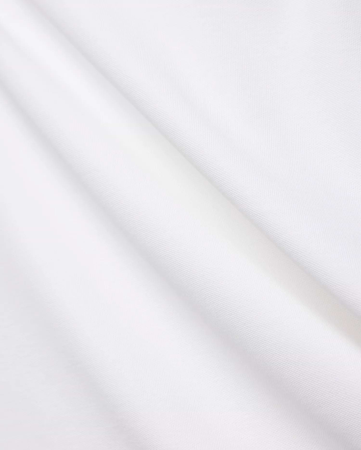 Crisp White Mens Brad Pique Polo fabric, highlighting its distinctive textured pique weave, soft, luxurious feel, and elegant folds, embodying premium Psycho Bunny menswear. (6)