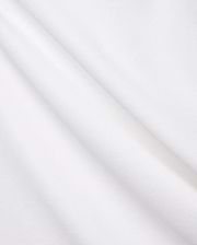 Crisp White Mens Brad Pique Polo fabric, highlighting its distinctive textured pique weave, soft, luxurious feel, and elegant folds, embodying premium Psycho Bunny menswear. (6)